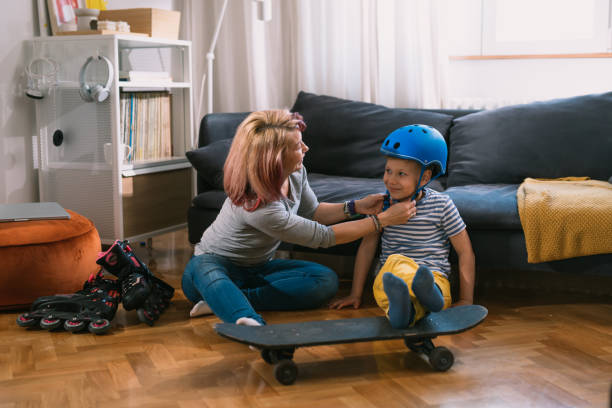 istock mother and son preparing for driving skateboard and rollerblade 1445359235