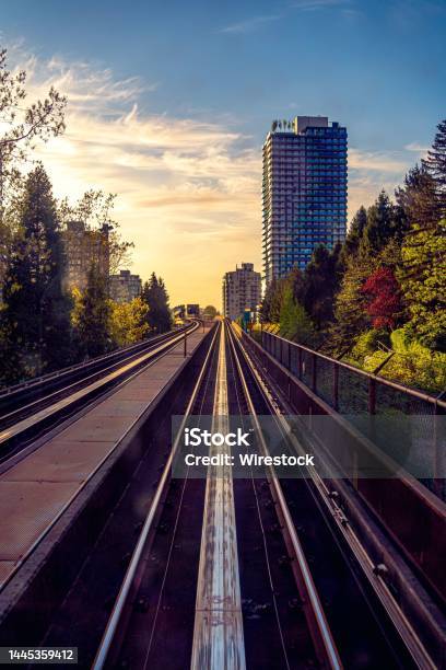 Beautiful View Of Skytrain Train Line Vancouver City Saturated With Sunset Buildings Trees Beautiful Stock Photo - Download Image Now