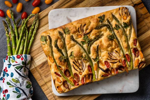 istock Top view of a cooked Focaccia bread with vegetable decorations on it 1445359466