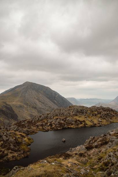 istock Vertical of a lake in the mountains under a cloudy sky. 1445360234