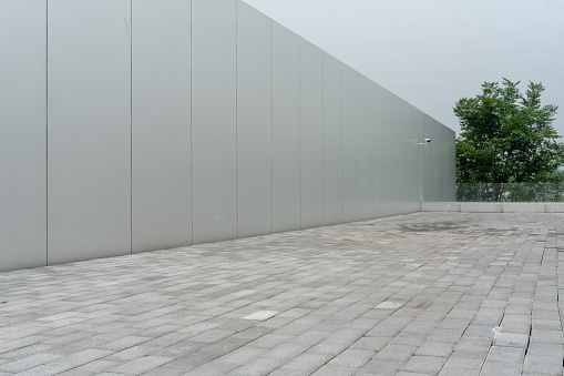 An empty ground floor in front of a modern architecture exterior.