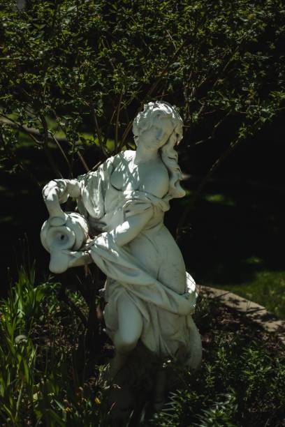 istock Woman statue holding a jar statue on the lake 1445364124