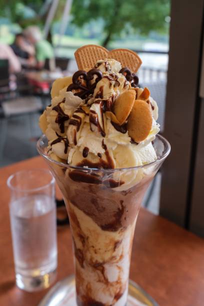 Vertical shot of a glass of banana split coffee ice cream in a restaurant in Grein, Austria A vertical shot of a glass of banana split coffee ice cream in a restaurant in Grein, Austria grein austria stock pictures, royalty-free photos & images