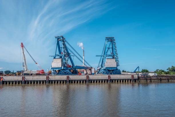 istock Industrial view of cranes on a harbor under a blue sky 1445365201
