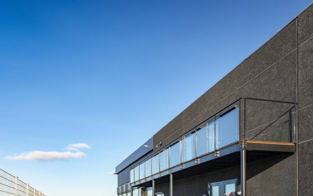 istock Modern building with glass windows against a blue sky 1445365832