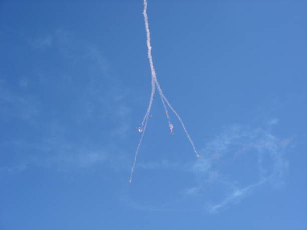 istock Parachutes coming down with pink smoke 1445367078