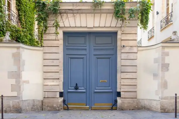 Paris, an old wooden door, typical building in the Marais