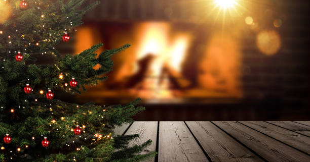 istock Christmas tree in foreground in front of blurred living room with fireplace 1445369049