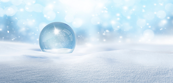 Snow globe with snowflakes in snow