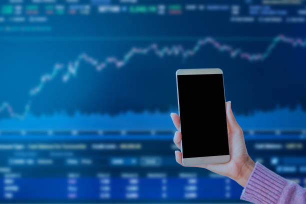 istock Hand Holding Mobile on Blur Business Technology Money Digital Growth Chart Grraph 1445371984