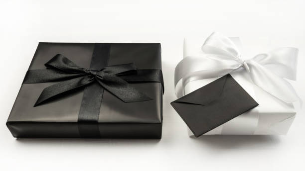 istock Gift white and black box with bow and envelope. White background. Holiday concept. Christmas. New Year. Valentine's Day. 1445372118