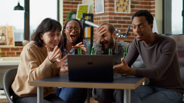 istock Cheerful people having fun with online internet videos 1445373043