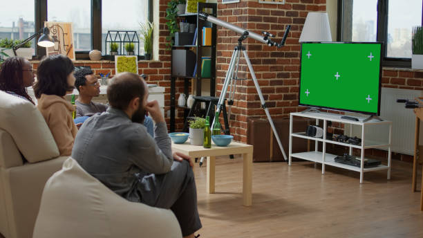 istock Men and women watching television with green screen 1445373120