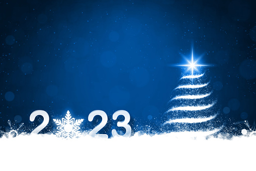 Happy New Year and Xmas background in contrasting colours of dark blue and white color with one Christmas tree illuminated with a star at the top and glittery snowflakes at the bottom and happy New Year text 2023. Can be used as New Year, Christmas festive wallpaper, backdrops, greeting cards templates or gift wrapping sheet.