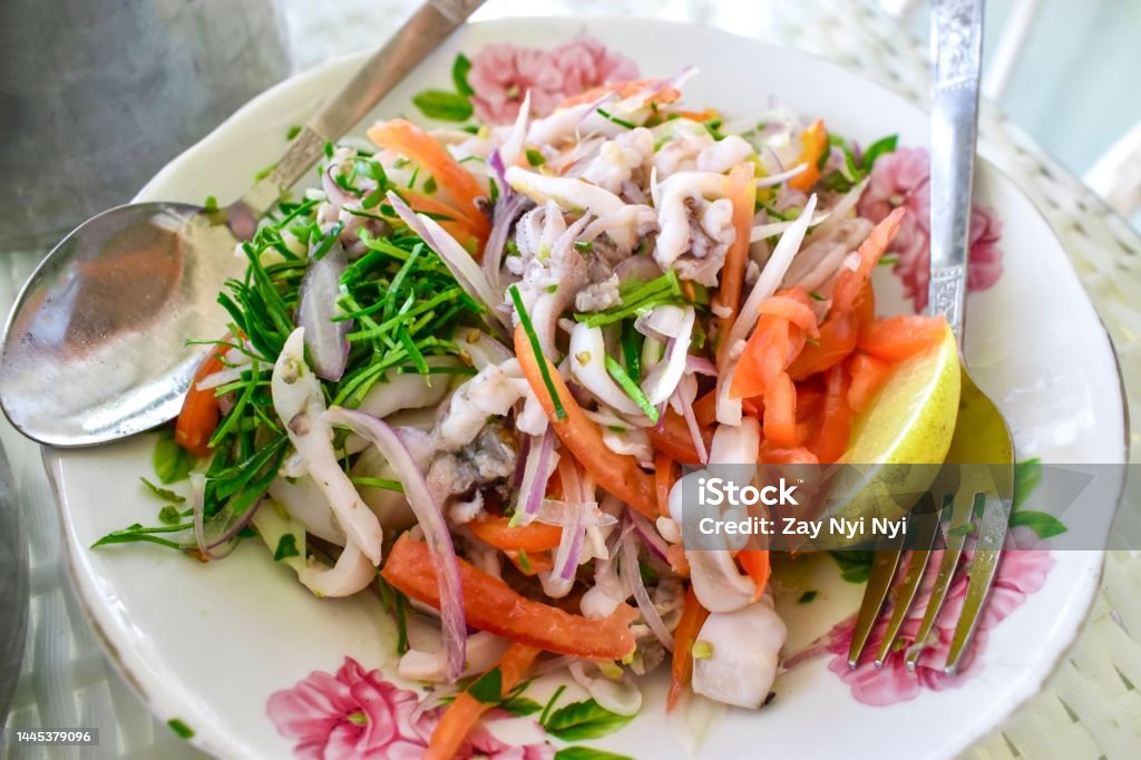 Myanmar or Burmese spicy squid salad. Favorite food of Chaungtha Myanmar or Burmese traditional spicy squid salad. Favorite food of Chaungtha Calamari Stock Photo