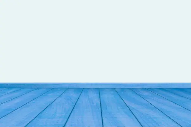 Mock-up of empty room with  textured realistic of blue wooden flooring leading towards a pale blue wall.