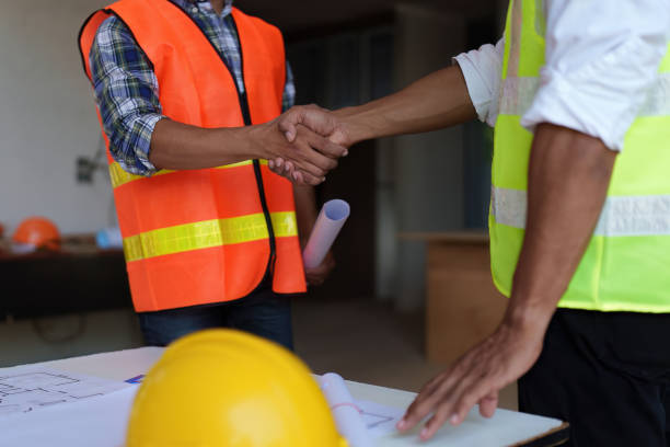 istock Architect and engineer construction workers shaking hands after finish an agreement in the office construction site, success collaboration concept 1445379922