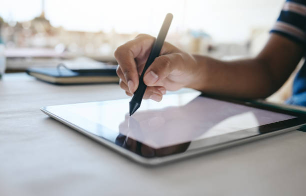 istock Digital tablet, designer hands writing with pen for design planning, creative animation or advertising project on desk in studio. Tech, notepad or web designer working with electronic pen, UX or web 1445379967