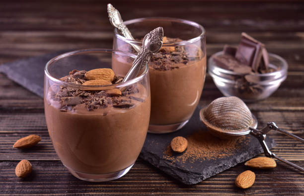 istock Chocolate mousse with almonds in glasses on a dark wooden background. 1445380329