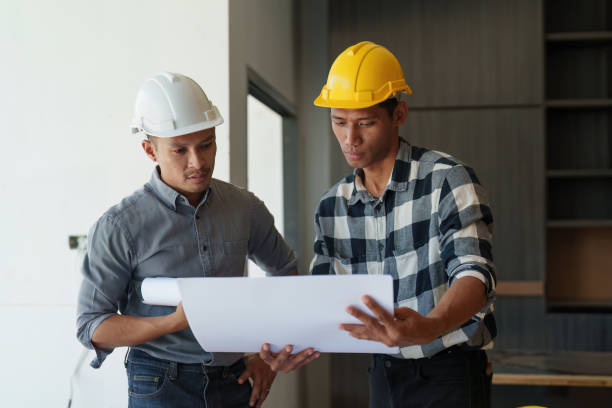Professional architect designer structural engineer team colleagues discussing building plan design project Professional architect designer structural engineer team colleagues discussing building plan design project. office buddies stock pictures, royalty-free photos & images
