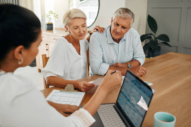 financial advisor consultation with clients on retirement, finance planning or investment and document on laptop screen. accountant woman, senior people and pension advice, asset management or budget - financieel adviseur stockfoto's en -beelden