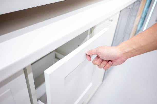 istock Male hand opening drawer on white cabinet 1445385403