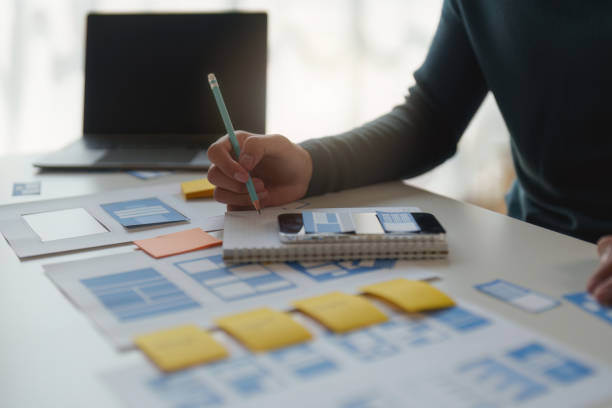 istock Group of UX UI or designers working to create content of mobile applications. Creative digital development agency concept 1445385964