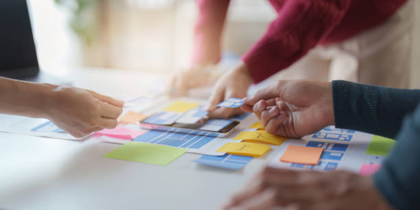 istock Group of UX UI or designers working to create content of mobile applications. Creative digital development agency concept 1445385997