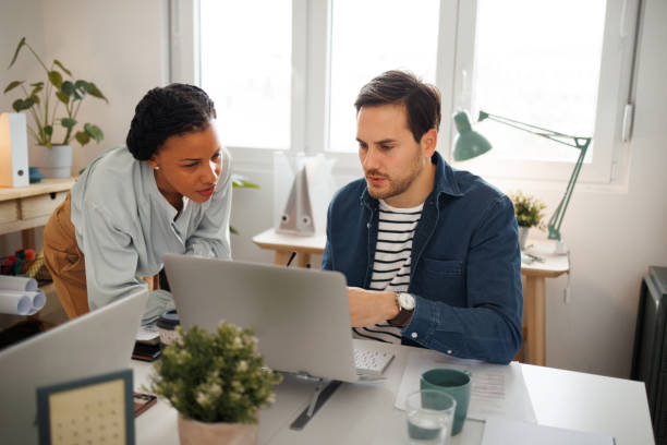 istock Colleagues cooperating in small home office 1445386115
