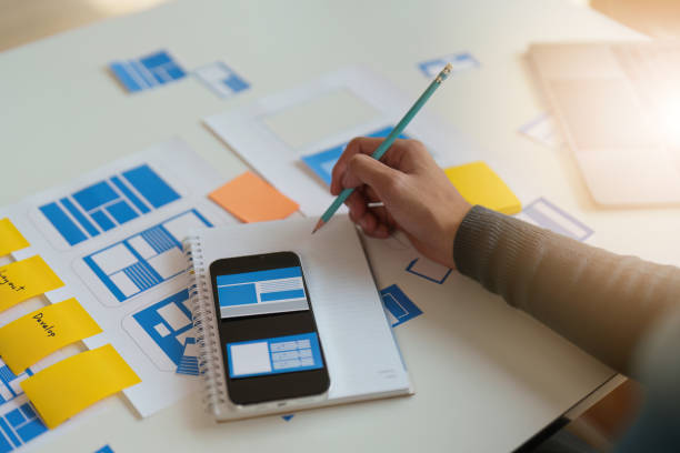 istock Group of UX UI or designers working to create content of mobile applications. Creative digital development agency concept 1445386136