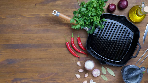 istock Black iron empty grill pan on wooden texture 1445386178