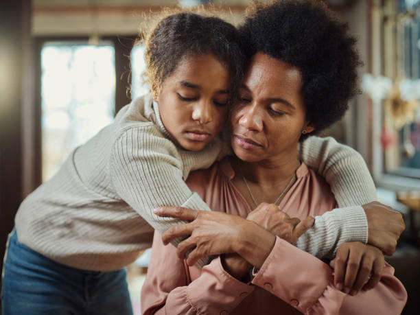 Don't be sad mommy! African American girl embracing her sad single mother at home. woman comforting depressed friend stock pictures, royalty-free photos & images