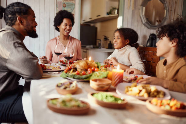 istock Happy black family talking during lunch in dining room. 1445387952