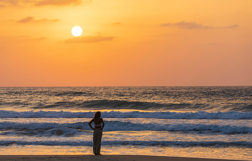 ISRAEL, Herzliya - October 05, 2022: Beach girl at sunset. Sunset on the Mediterranean coast