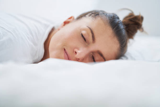istock Nice female in bed relaxing or doing yoga 1445388757