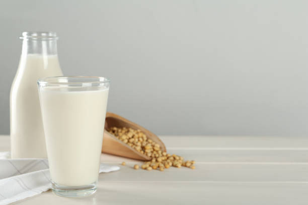 istock Fresh soy milk and grains on white wooden table. Space for text 1445391449