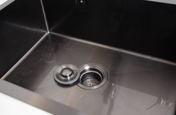 istock Modern stainless steel sink with drain plug. Water filling. Copy space for text 1445391710
