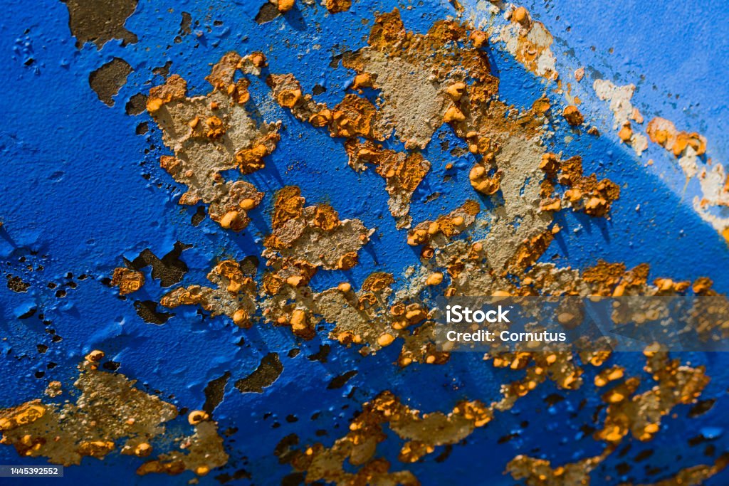 rust, oxidation, paint, flaking, whimsical, sky blue, yellow, brown, shipping, ship, exterior, pleasure boating, maintain, scrape off, derust, winter, abrade, chip off, fresh water, enemy, oxygen, corrosion, affect, iron oxide, connection, chemical, chemi Yellow-brown rust spots and rust blisters have formed on the blue steel hull of a motorboat due to weathering and insufficient maintenance. Alloy Stock Photo
