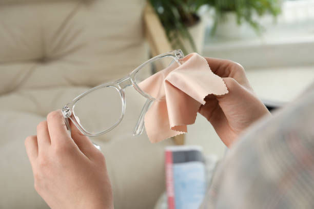 istock Woman cleaning glasses with microfiber cloth at home, closeup 1445392982