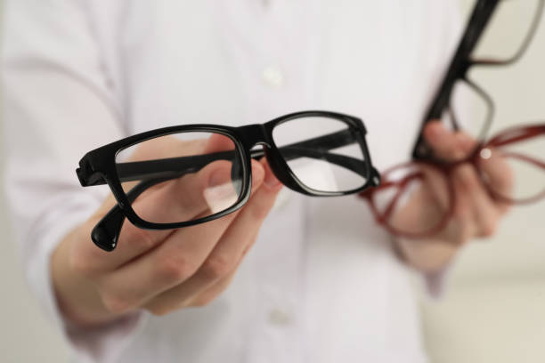 istock Woman with different glasses on light background, closeup 1445393037