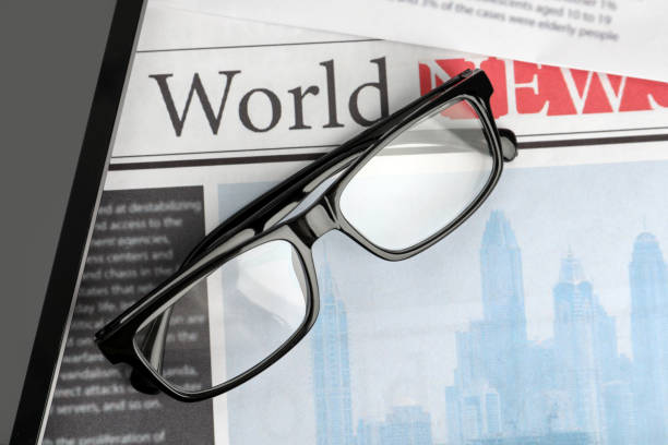 istock Glasses and tablet on newspapers, flat lay 1445393200