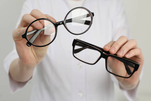 istock Woman with different glasses on light background, closeup 1445393317
