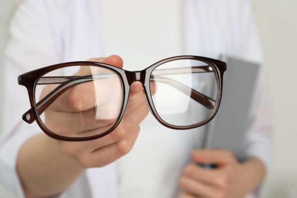 istock Woman with glasses on light background, closeup 1445393550