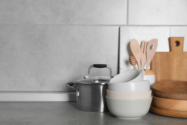 istock Cooking utensils and other kitchenware on grey countertop. Space for text 1445393552