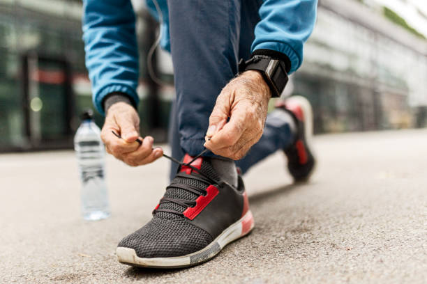 istock Senior runner ties the shoelace 1445394193
