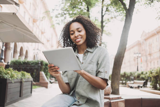 istock Happy woman using digital tablet in a city 1445394225