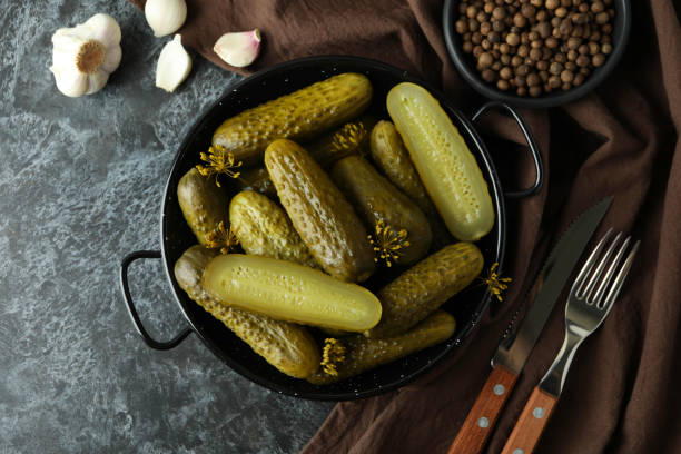 istock Fresh pickles and spices on black smokey table 1445394800