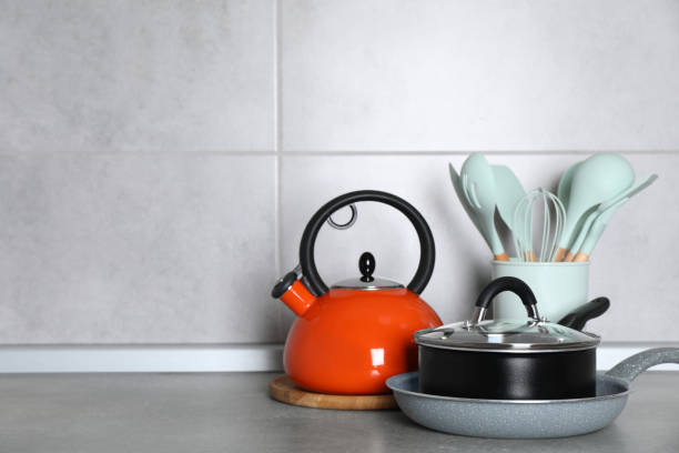 istock Cooking utensils and other kitchenware on grey countertop. Space for text 1445394983