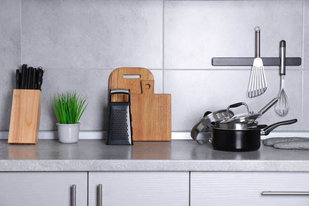 istock Set of cooking utensils and cookware on grey countertop 1445395074