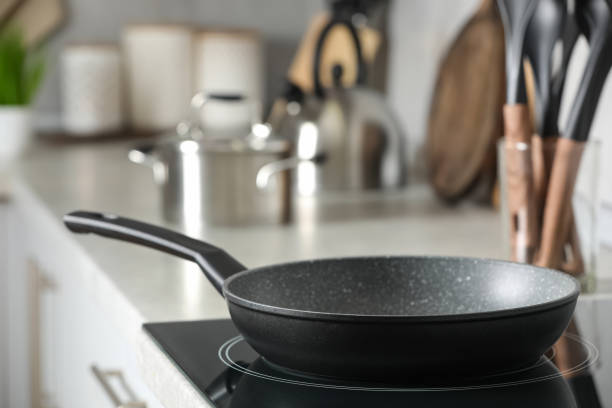 istock Frying pan and cooking utensils in kitchen, space for text 1445395076